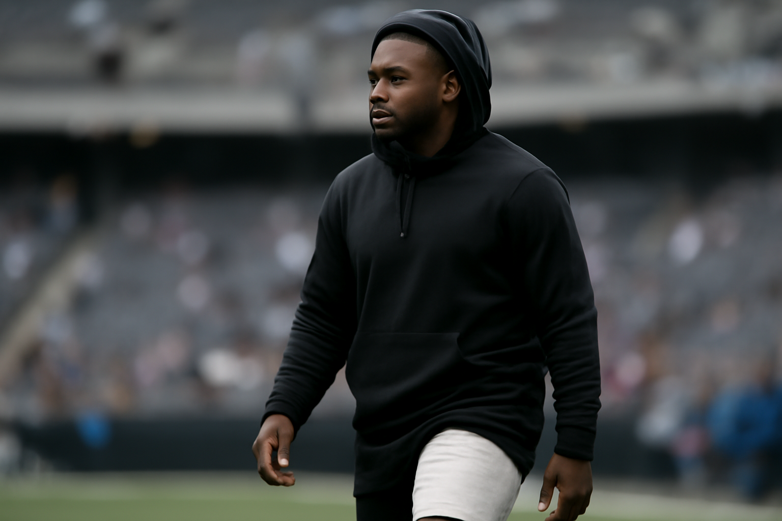 Philadelphia Eagles running back standing on the sideline in street clothes during pregame warmups
