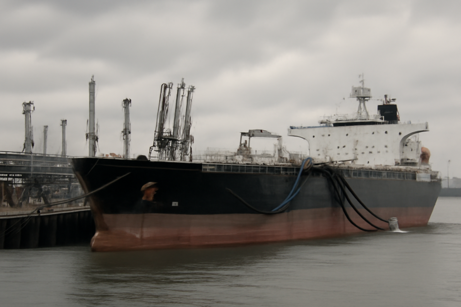 Oil tanker loading diesel fuel at a Russian export terminal under overcast skies