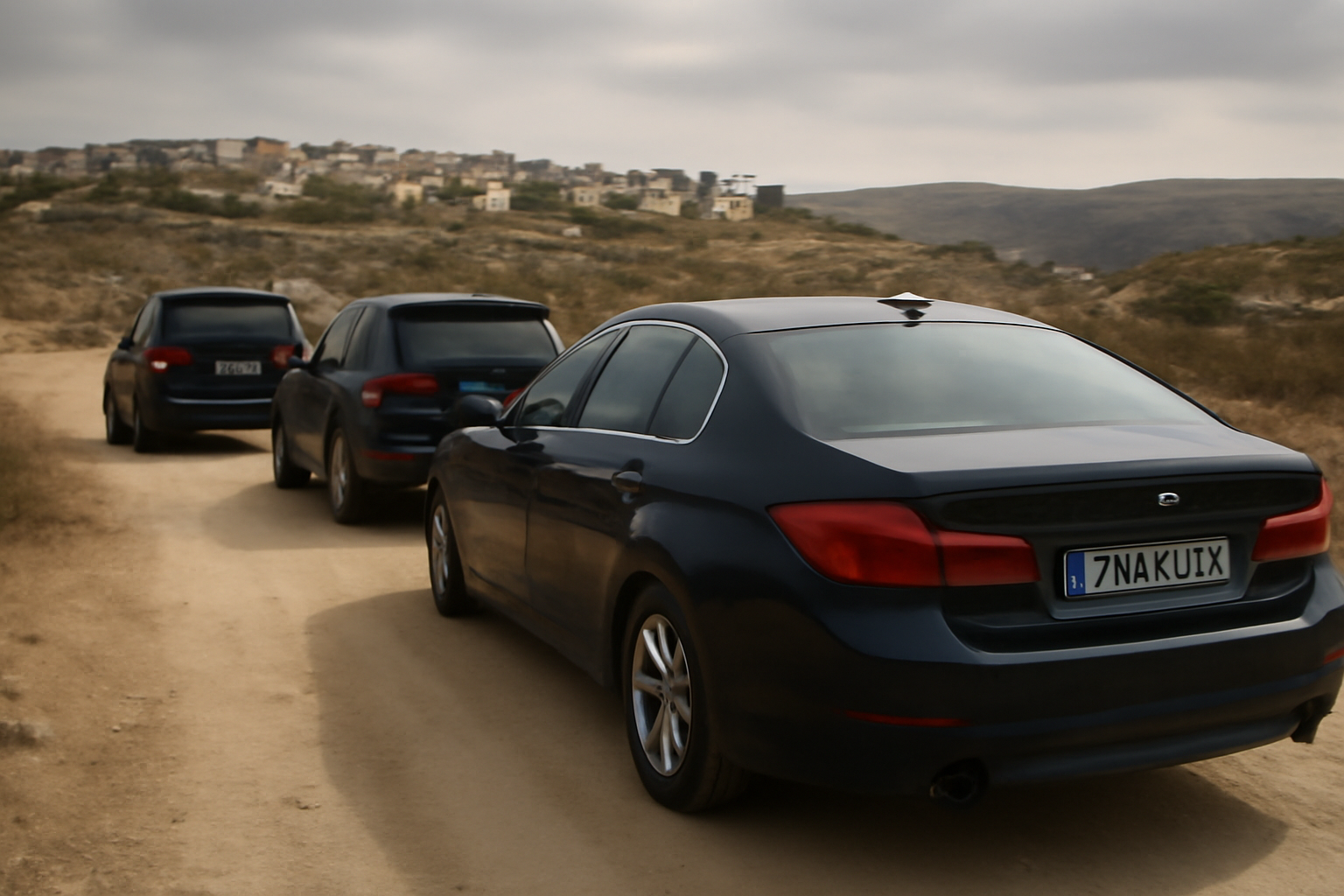 European diplomatic vehicles with EU plates stopped on a rural West Bank road near settlement hills