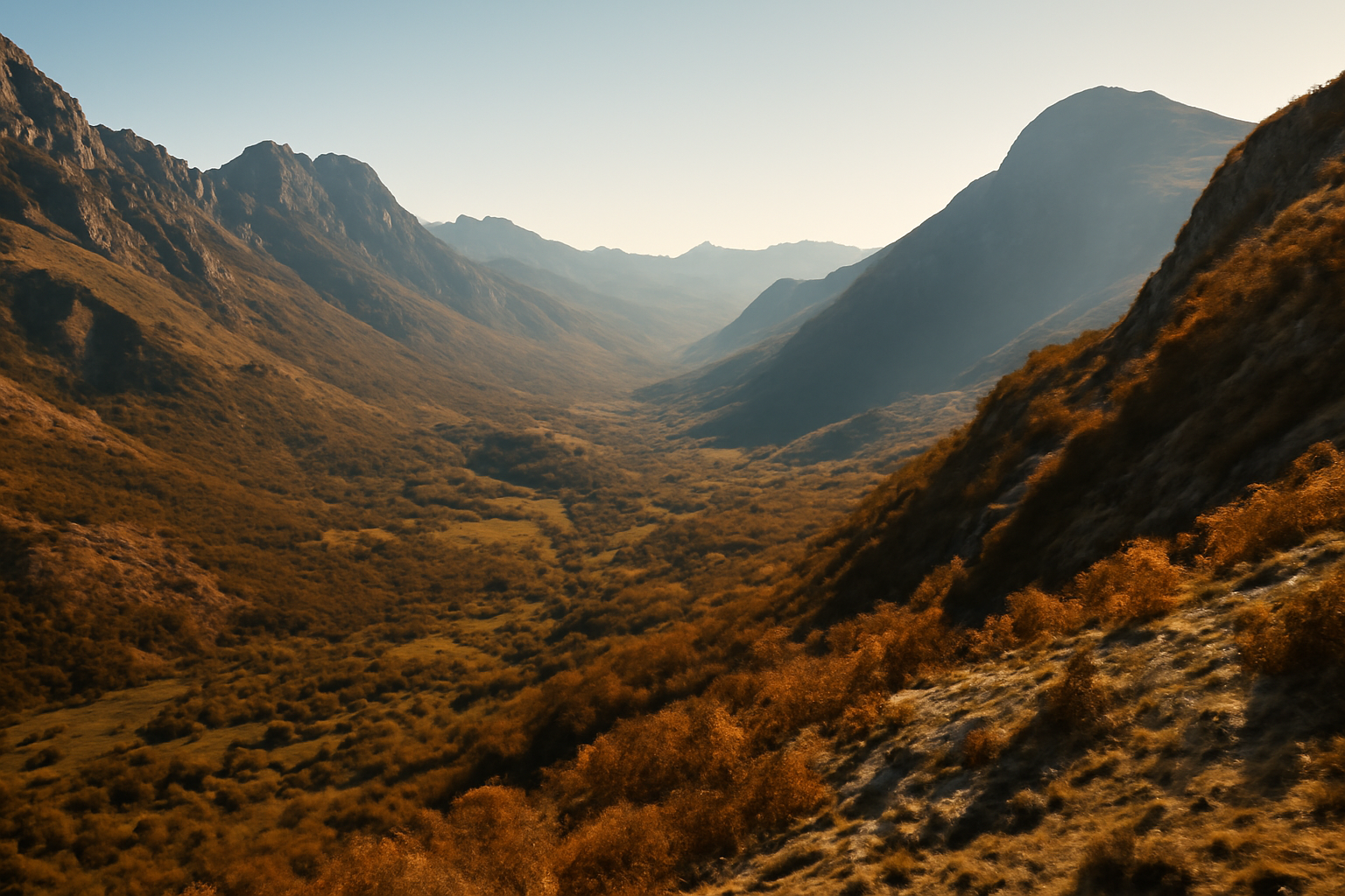 Sunlit mountain valley in Montenegro with clear skies over rugged terrain