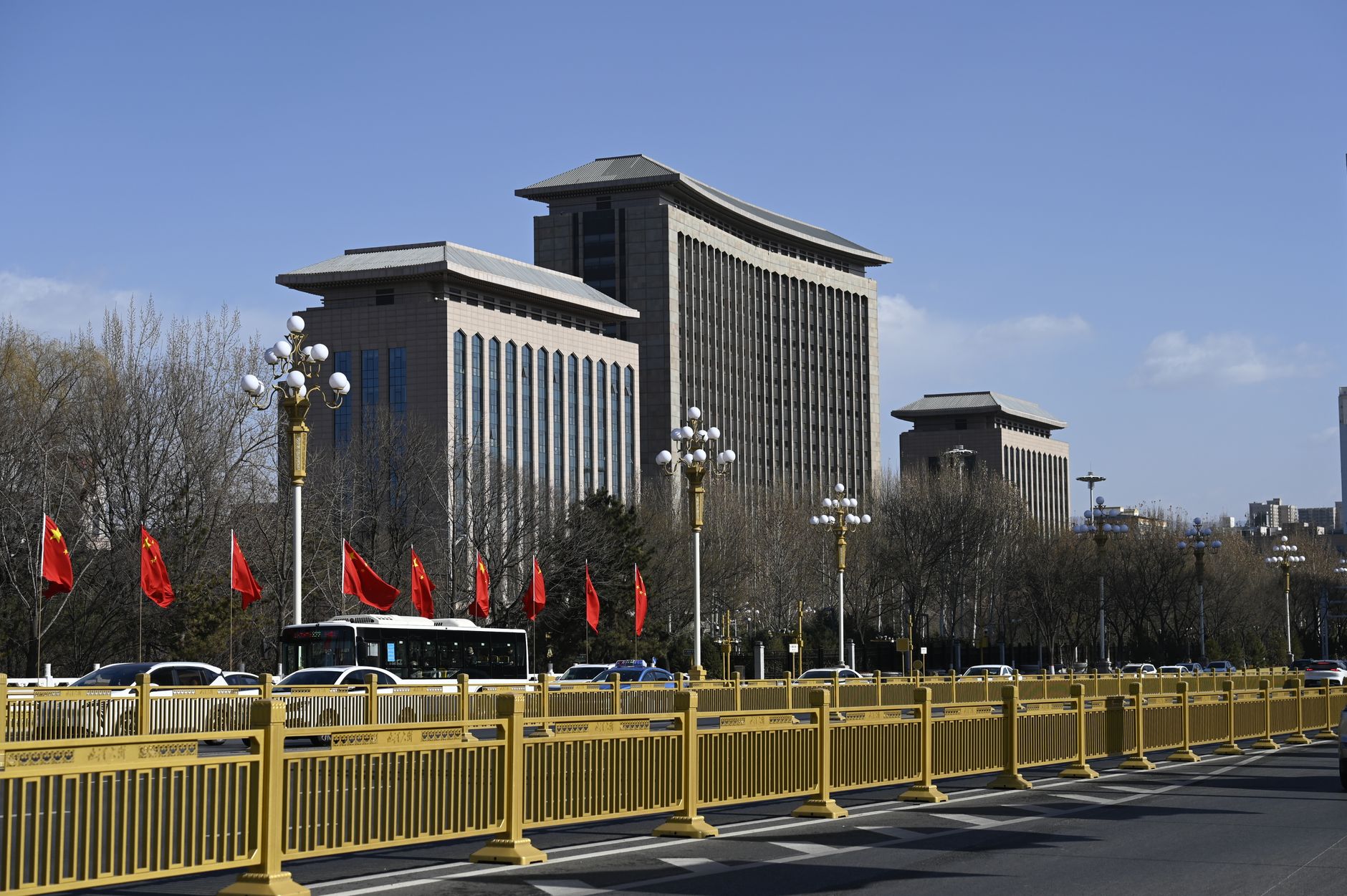 Empty formal meeting hall with rows of red chairs and a podium, suggesting a Communist Party session