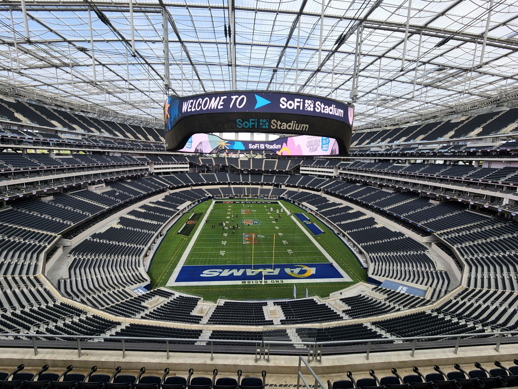 Empty stadium stage rigged with lighting and speaker towers ahead of a televised halftime performance