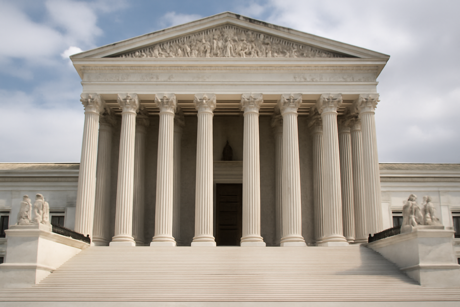 Exterior of the U.S. Supreme Court building with its marble columns under a clear sky