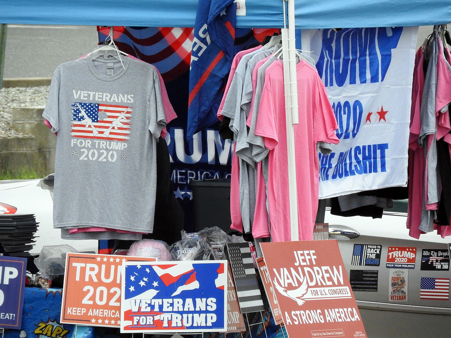 A campaign rally stage set up outdoors in Mississippi with American flags and a podium