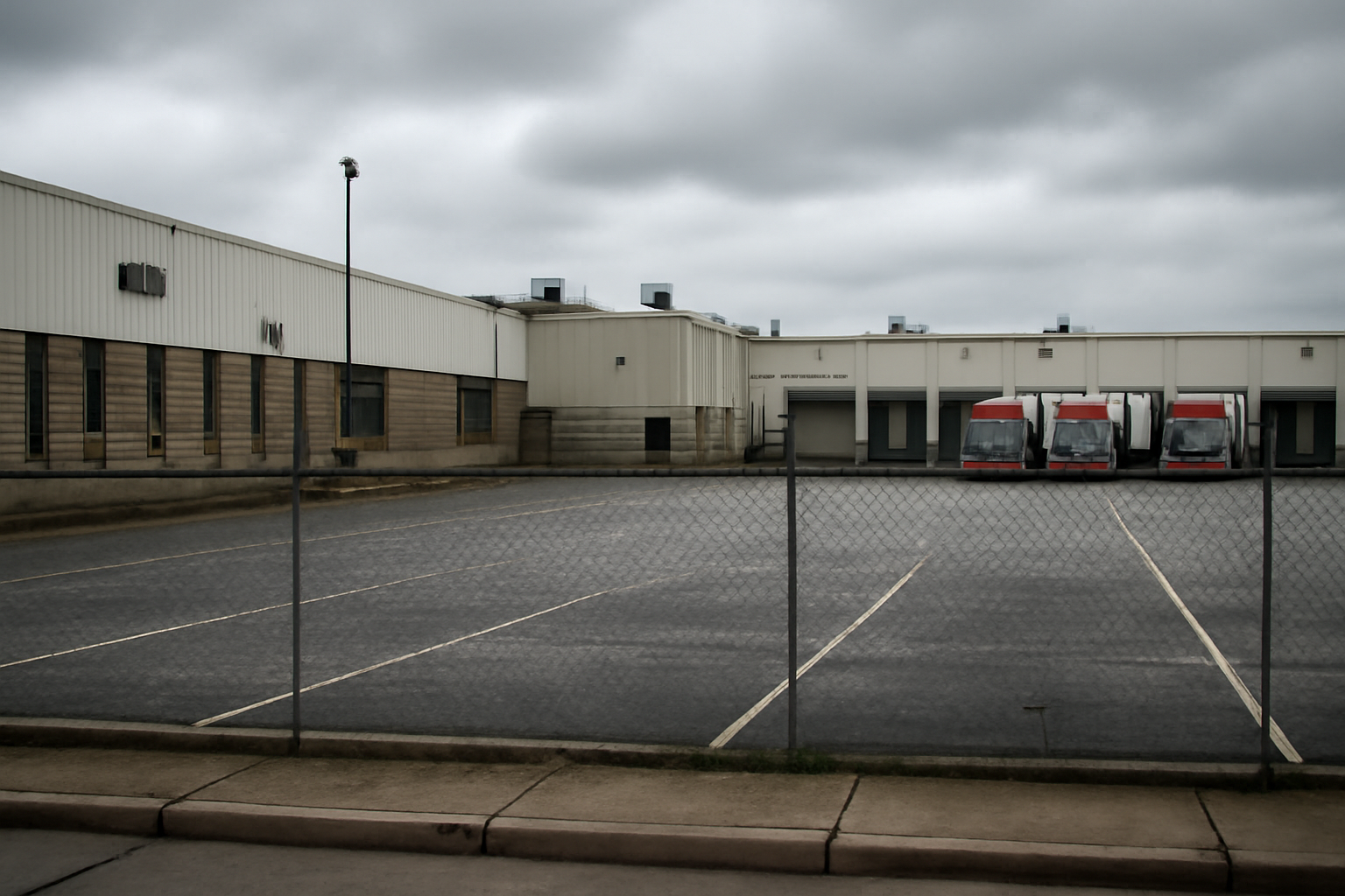 Closed gate and empty parking lot outside a large truck manufacturing plant in Ohio