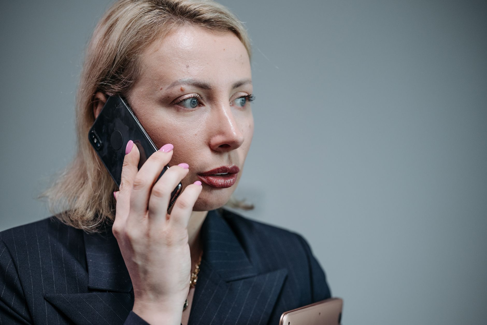 A telephone on a government desk with Norwegian and Finnish flags beside a wall map of Northern Europe and Russia