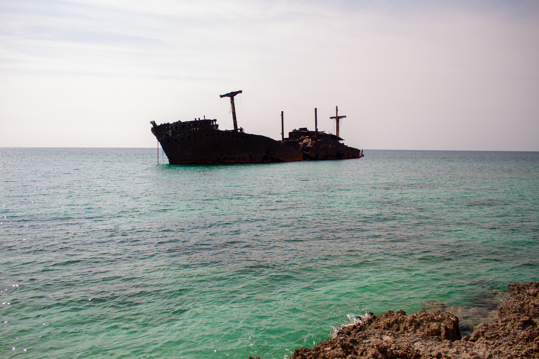 Undersea fiber-optic cable landing station on a Persian Gulf coastline at dusk