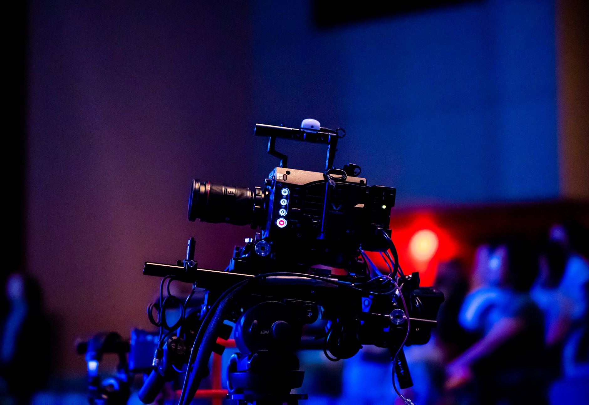 Television camera operators positioned around a packed football stadium during a night match