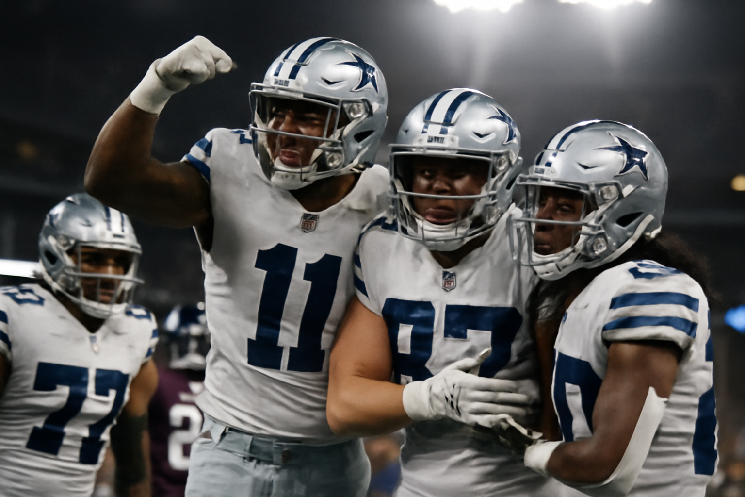 Dallas Cowboys players celebrating on the sideline during a Week 4 win over the Houston Texans
