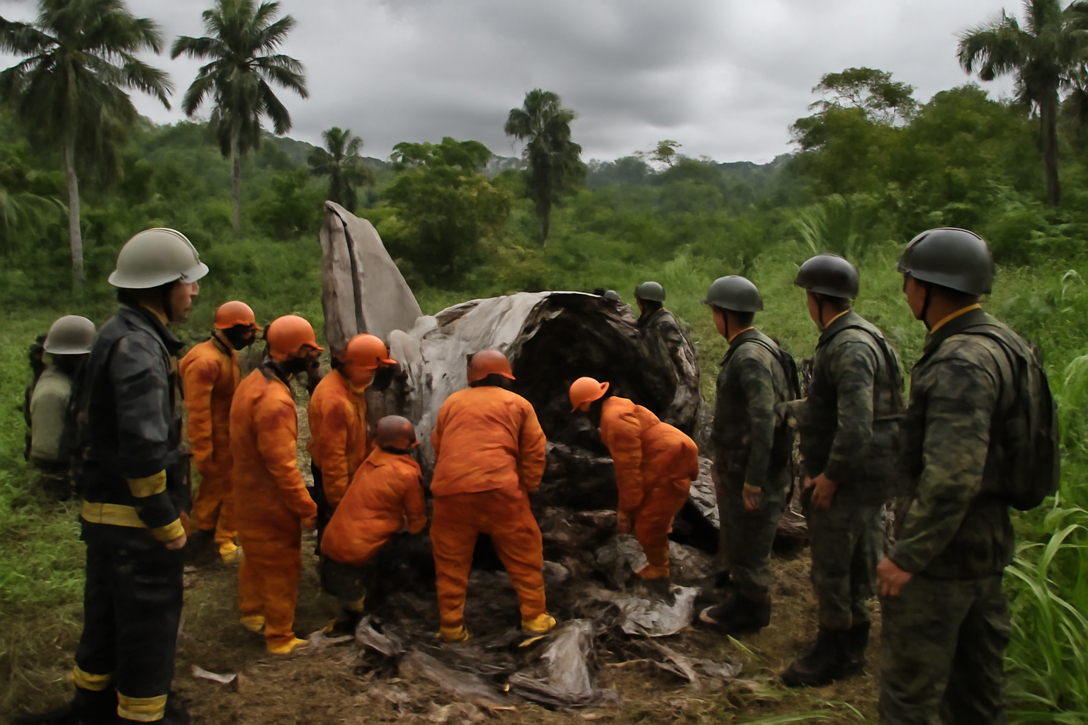 Emergency responders at the site of a military aircraft crash in a rural area of southern Nigeria