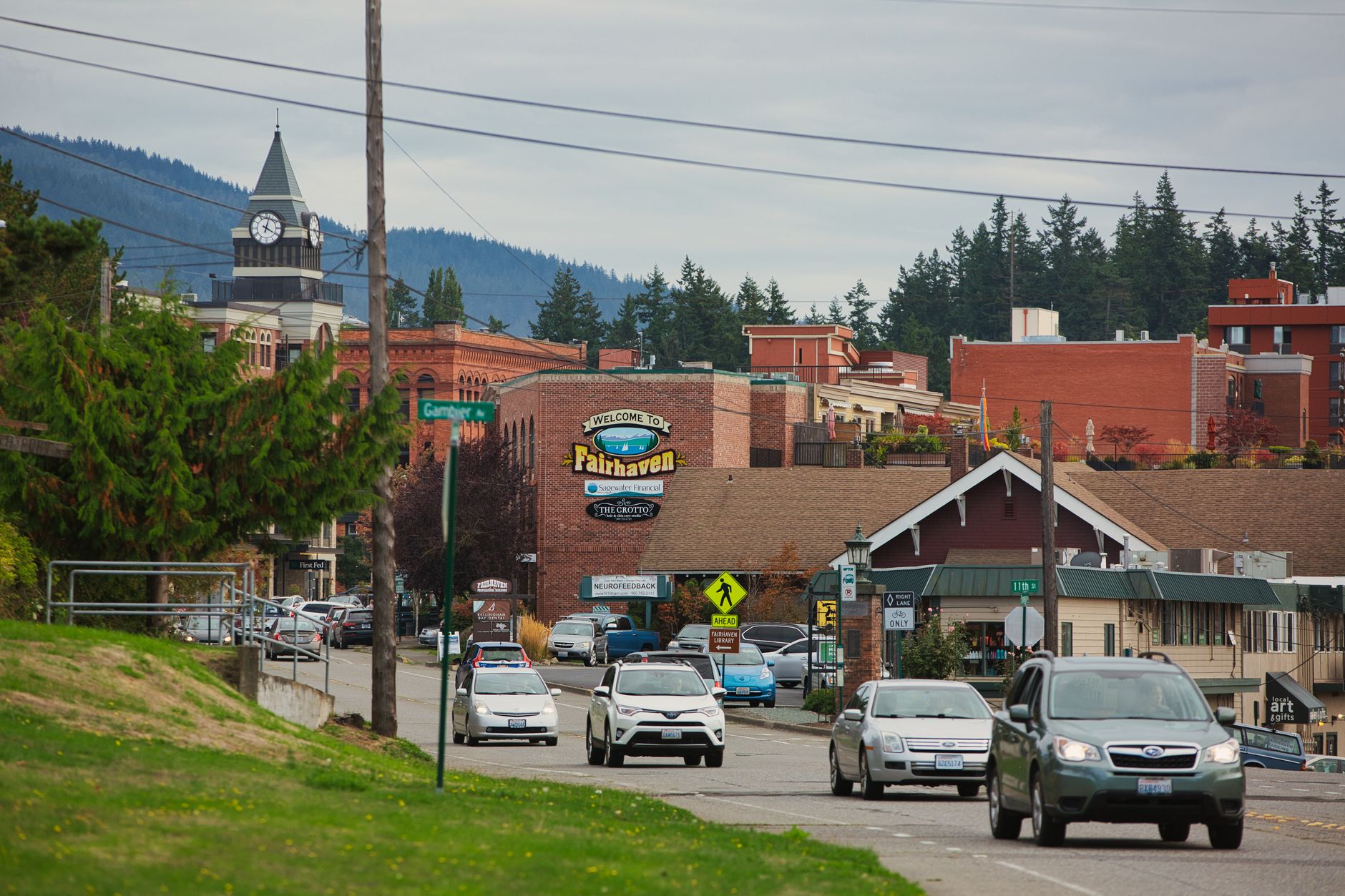 A tense exchange at a crowded municipal town hall meeting with officials and residents nearby
