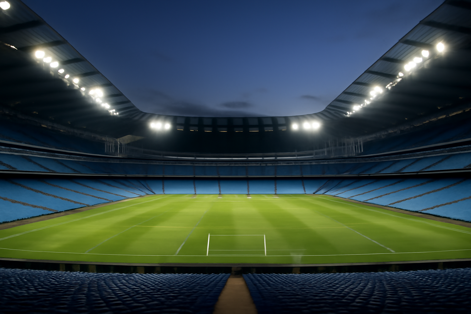 Empty Manchester City stadium seating under stadium floodlights before a match