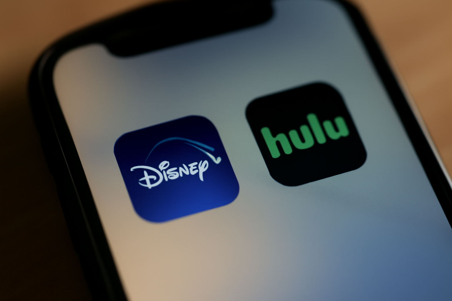 Disney+ and Hulu app icons shown together on a smartphone screen