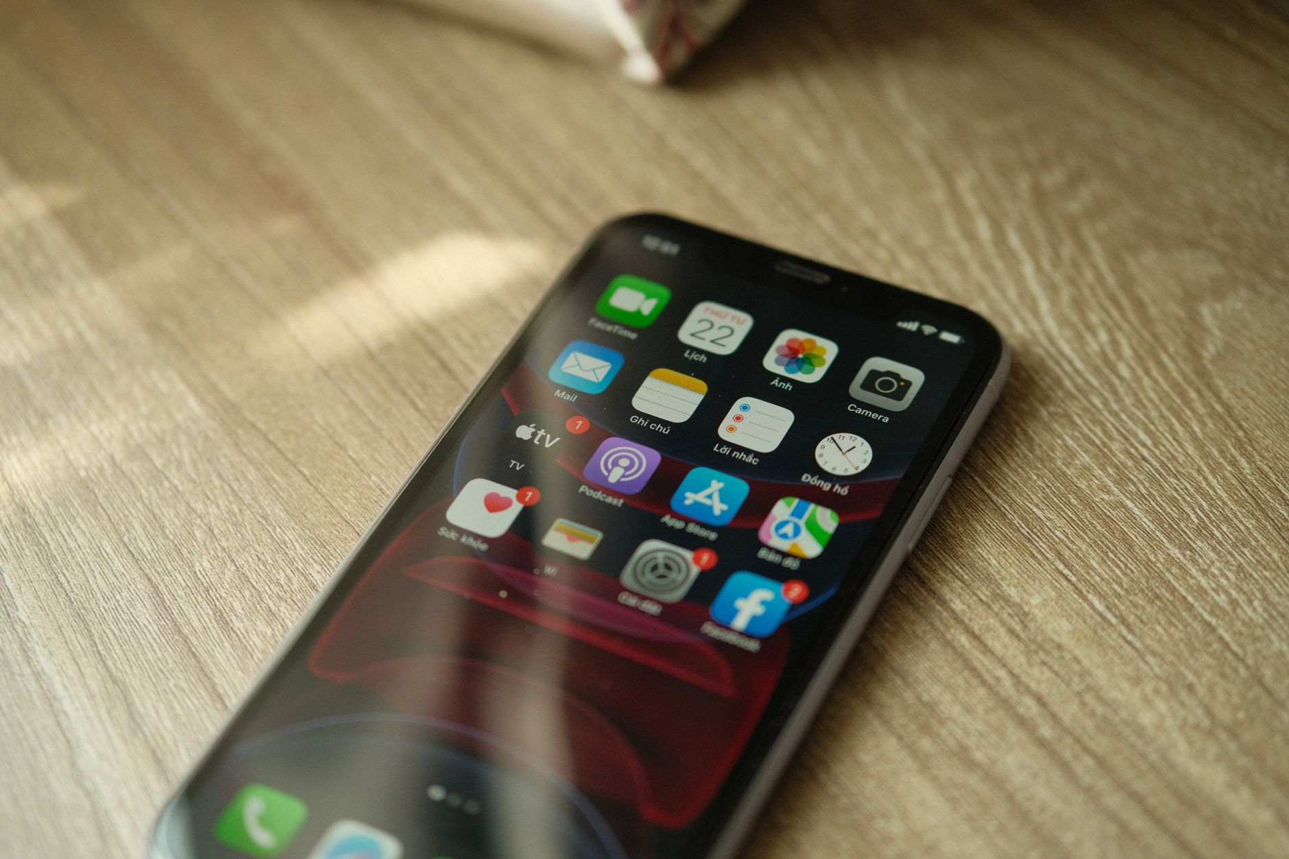 A foldable smartphone open at an angle showing a streaming app split across two screens