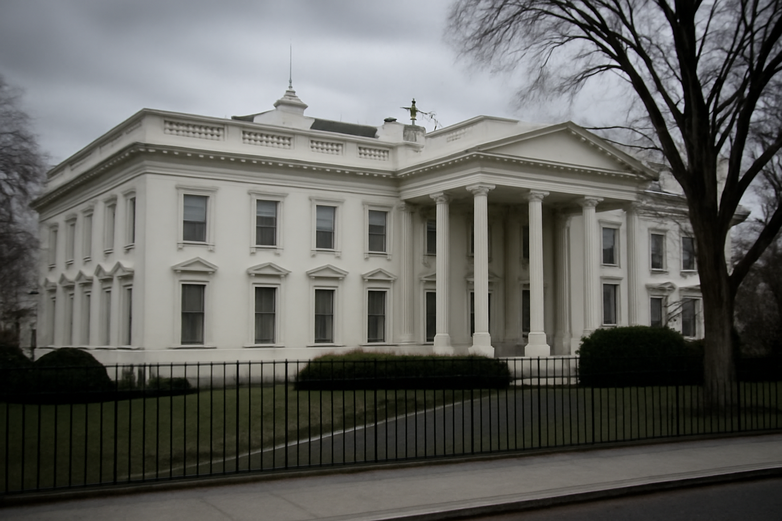 Exterior view of the White House West Wing entrance under overcast sky