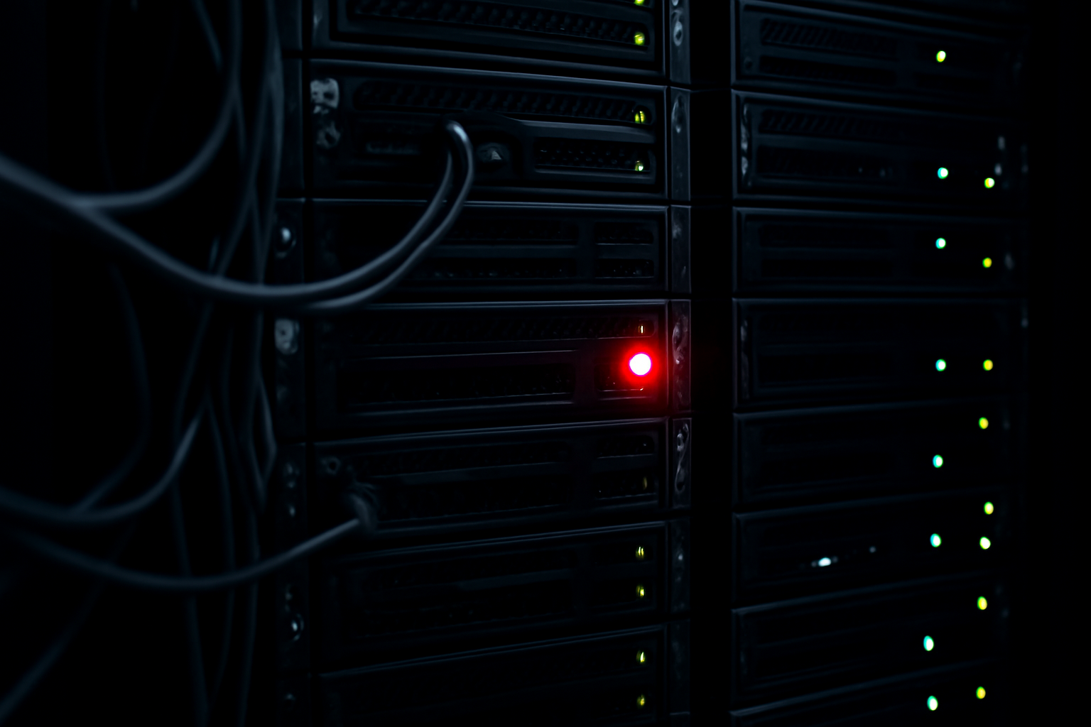 Server room with a red warning indicator on a rack-mounted web server