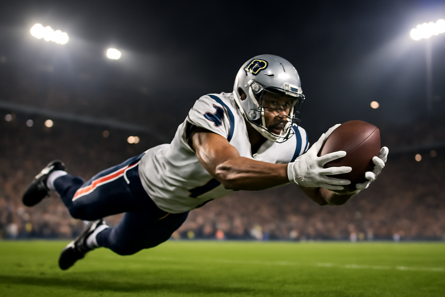 A New England Patriots wide receiver in white and blue jersey reaching unsuccessfully for a football during a game at Gillette Stadium