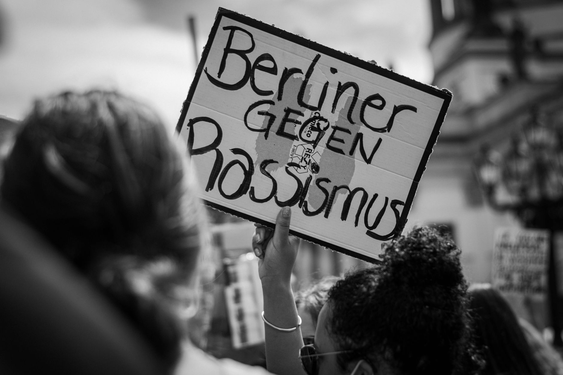 Young demonstrators gather in a German city street at dusk for a Halloween-timed protest march.