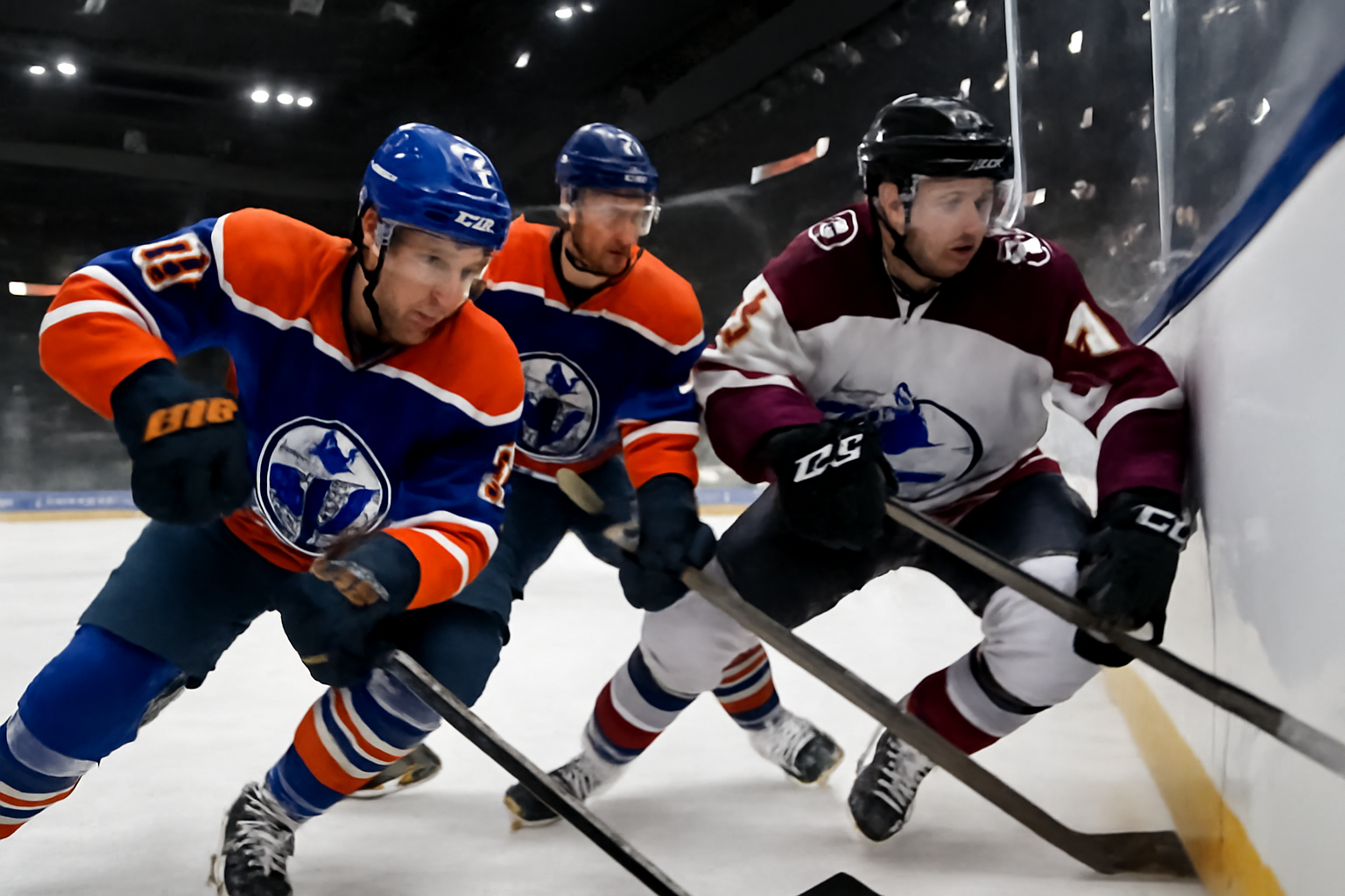 Hockey players in Islanders and Devils jerseys battling for the puck along the boards during a preseason game