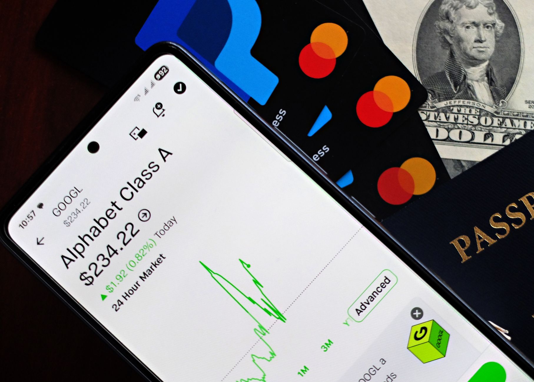 Google search homepage displayed on a laptop screen next to Alphabet quarterly earnings charts