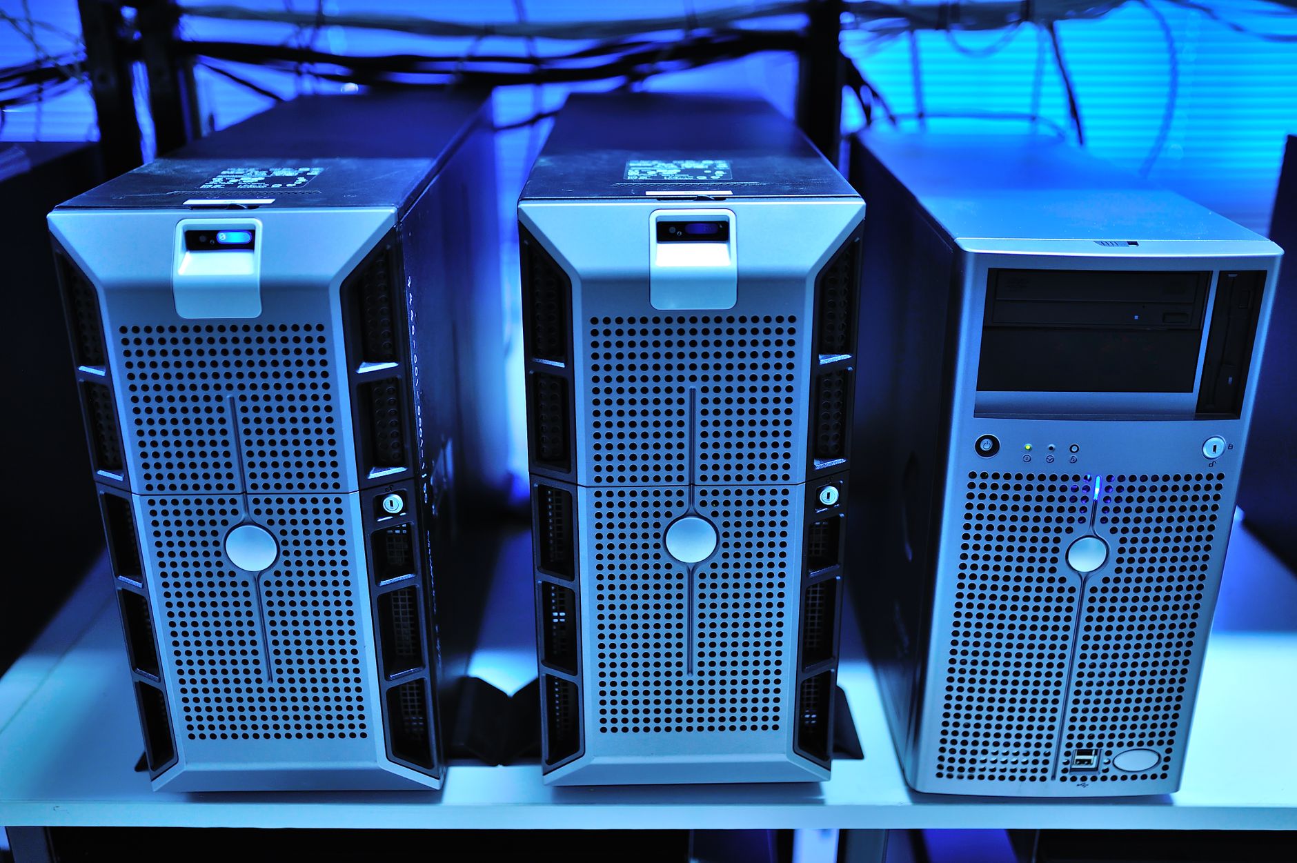 Rows of server racks inside a data center with blue indicator lights
