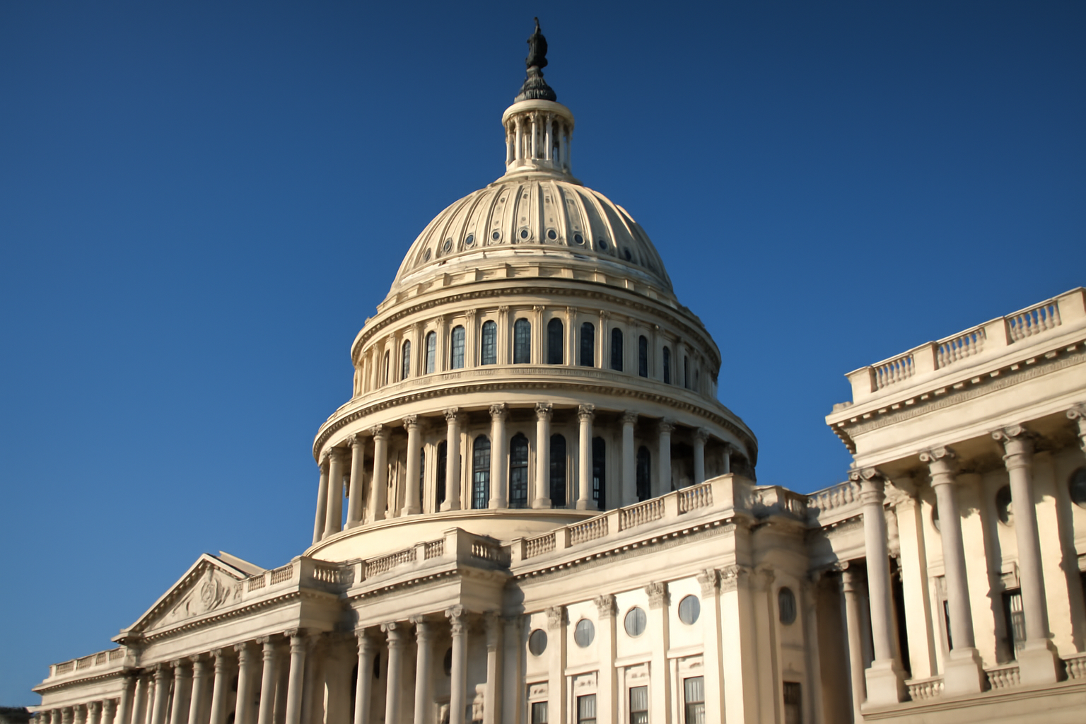 Exterior of the U.S. Capitol building under a clear afternoon sky