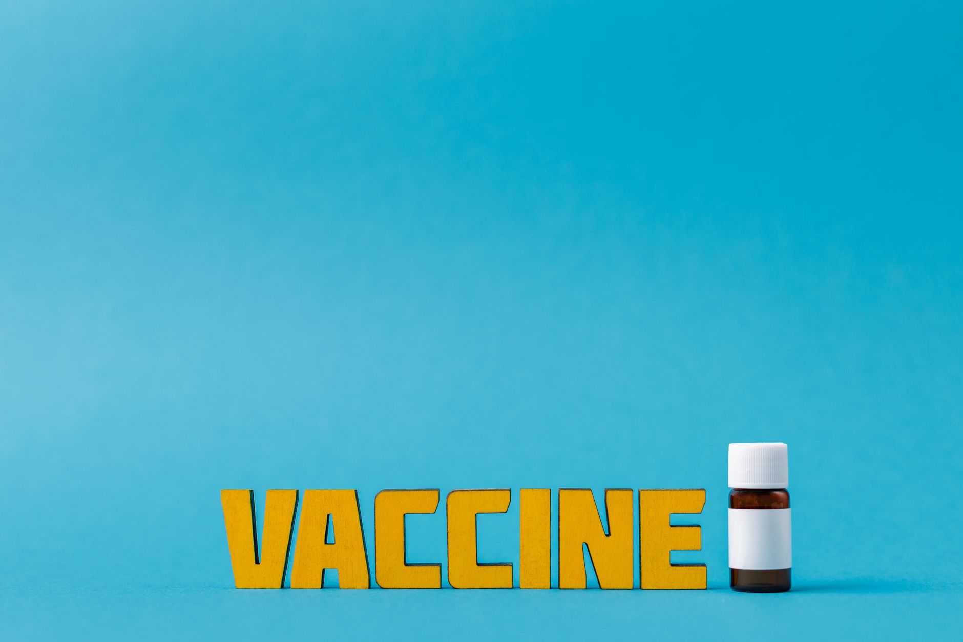 A healthcare worker preparing a vaccine syringe at a clinic counter