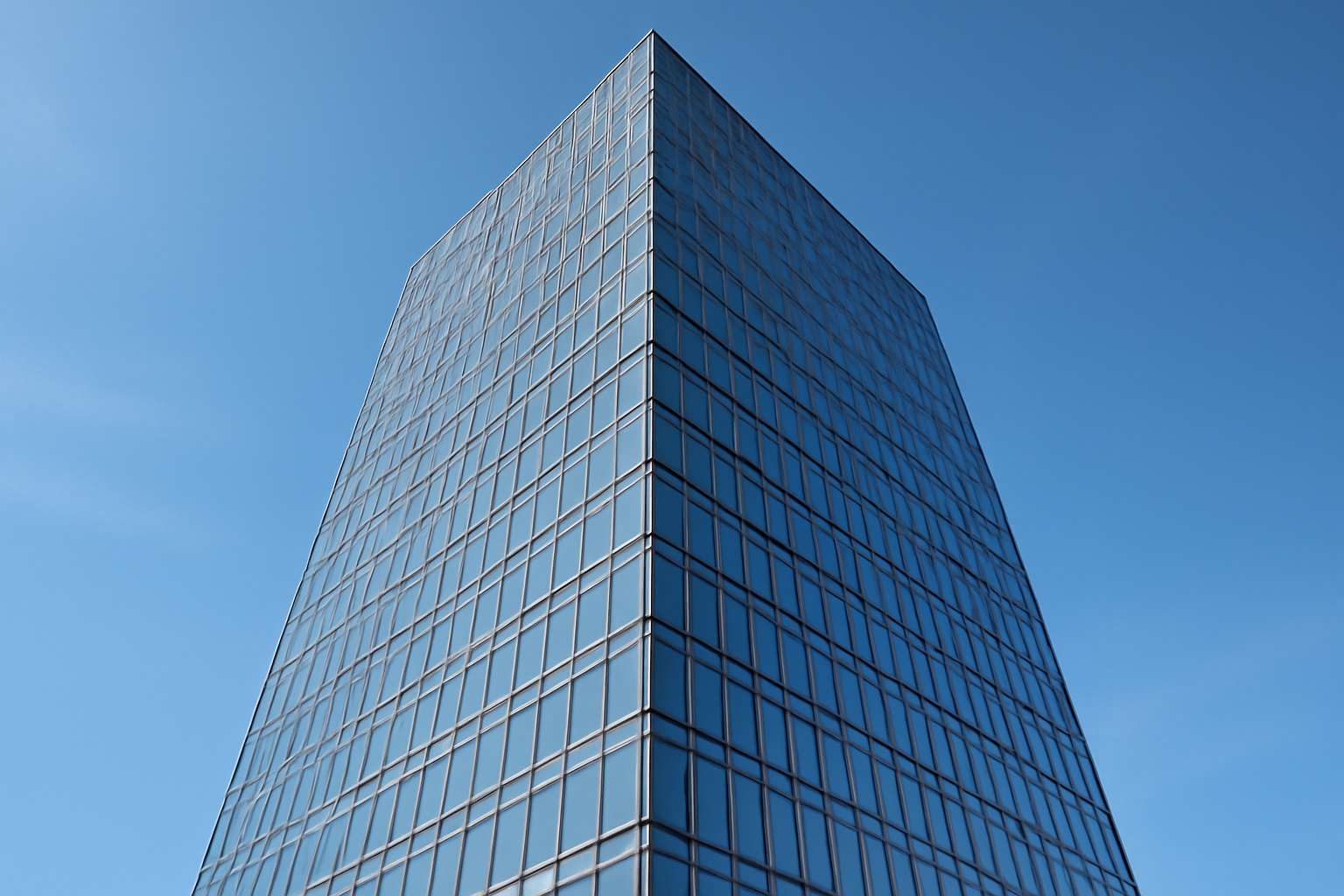 Glass office tower against a clear sky representing a technology company preparing for a public stock listing