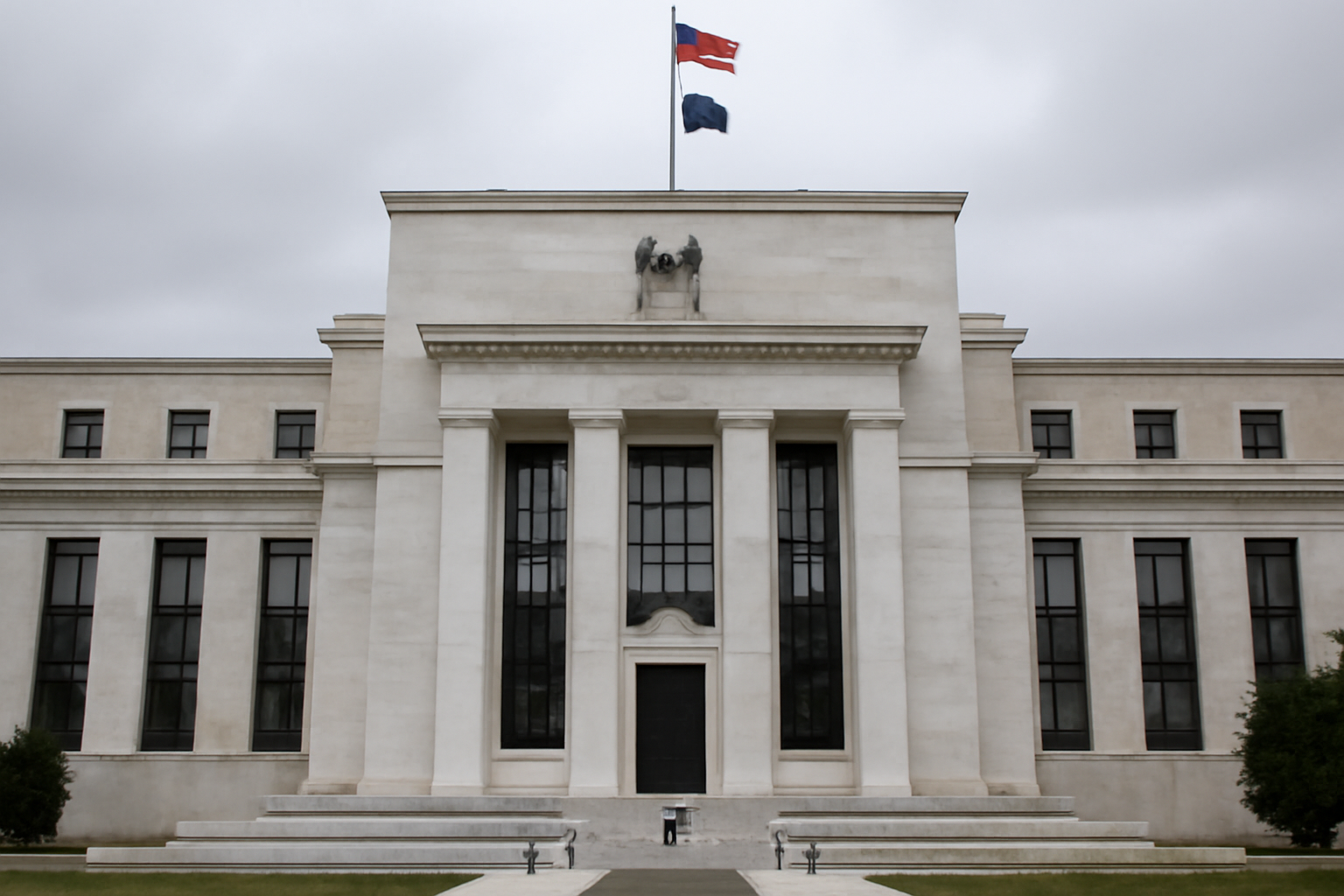 Federal Reserve building exterior with a flag in the foreground under daytime sky