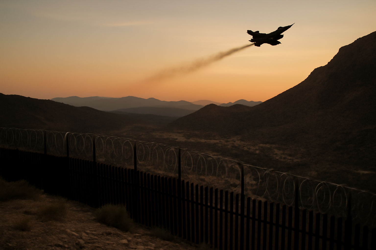 Military aircraft flying over a mountainous stretch of the Pakistan-Afghanistan border region