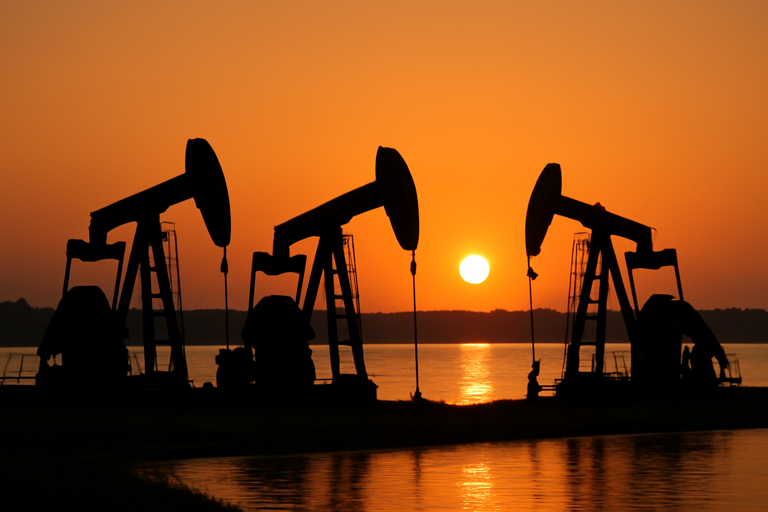 Oil pumpjacks operating at the edge of Lake Maracaibo in Venezuela
