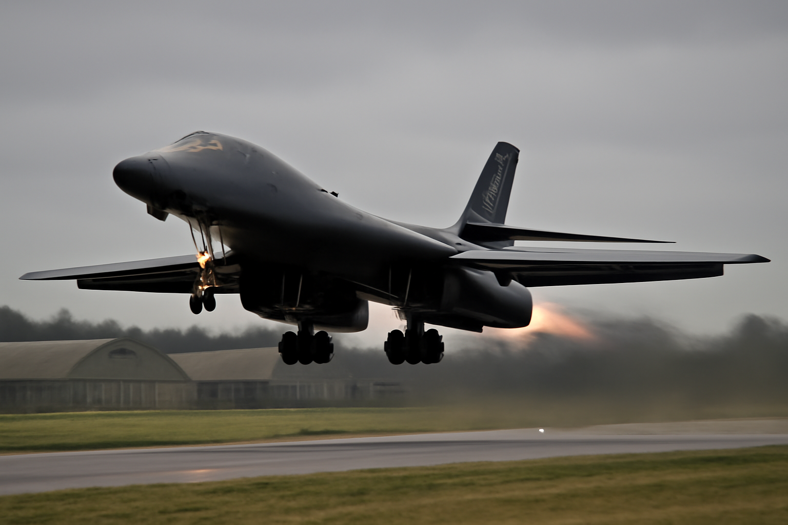A B-1 Lancer bomber taking off from a runway at a Royal Air Force base in England