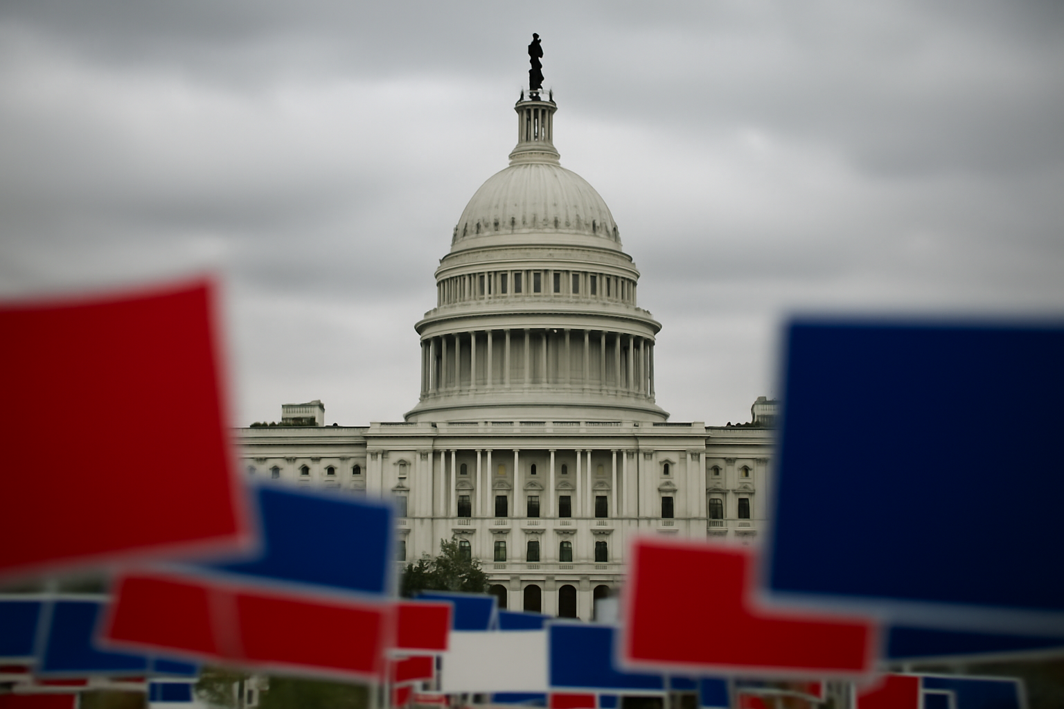 Republican campaign signs and a United States Capitol dome under overcast sky