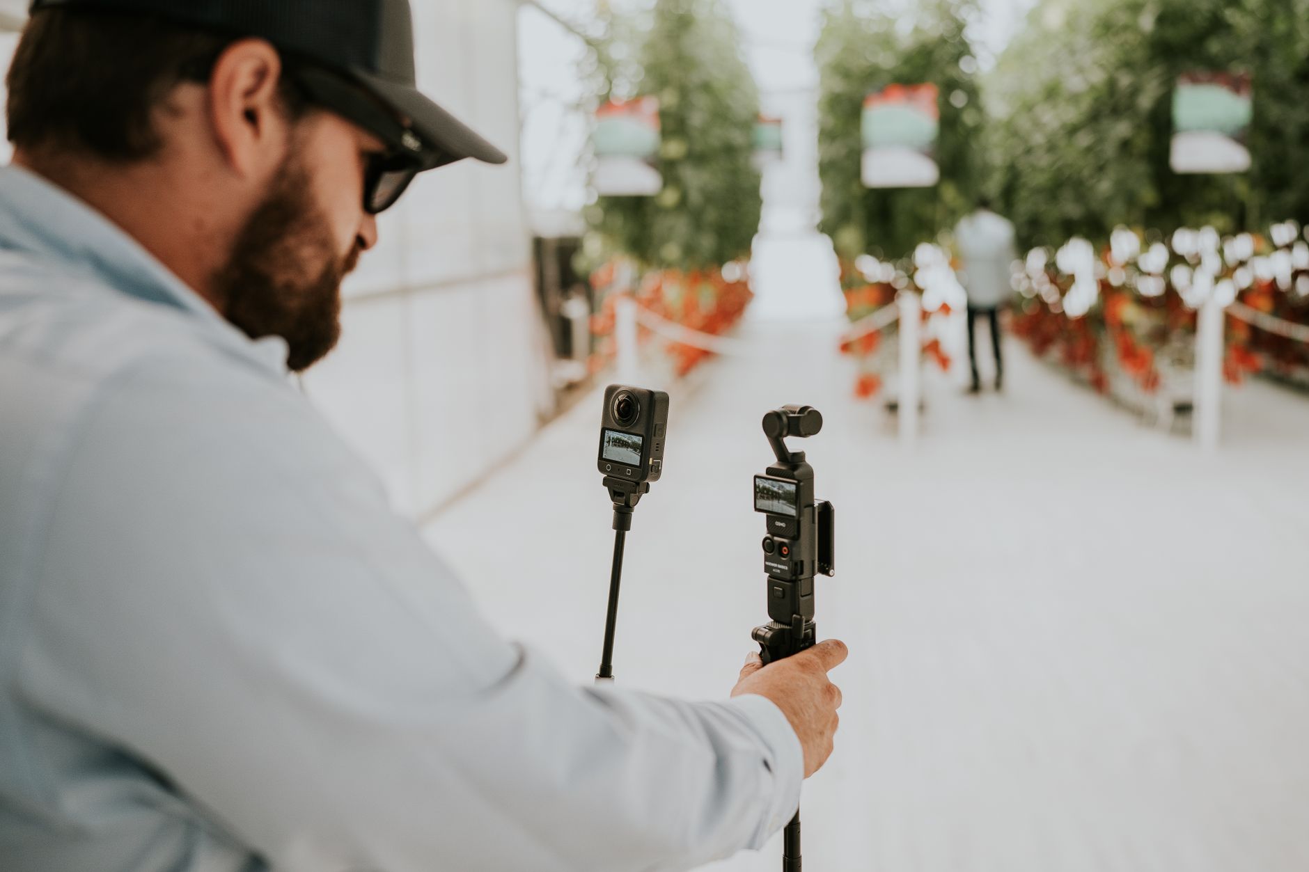 Director sits for an interview beside a film camera and monitor on a festival set