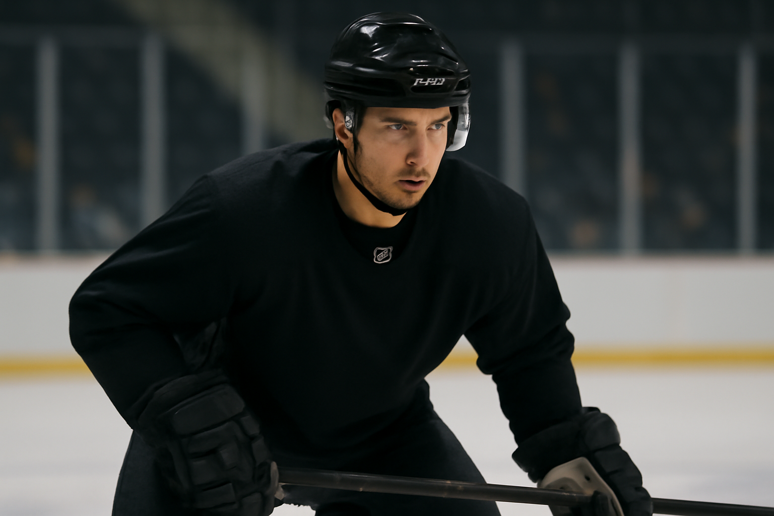 Hockey player in Pittsburgh Penguins jersey skating during practice