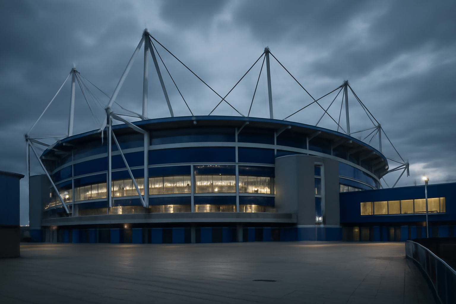 Goodison Park stadium exterior under overcast sky with Everton crest visible on the facade