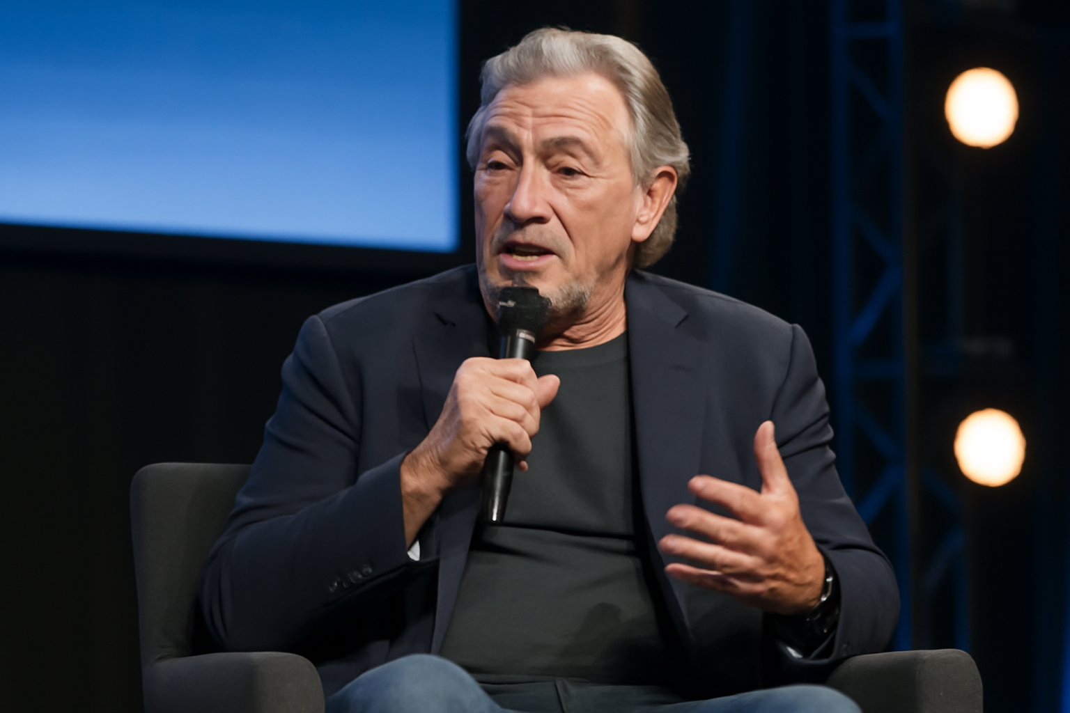 Actor speaking on stage during an interview at a technology conference