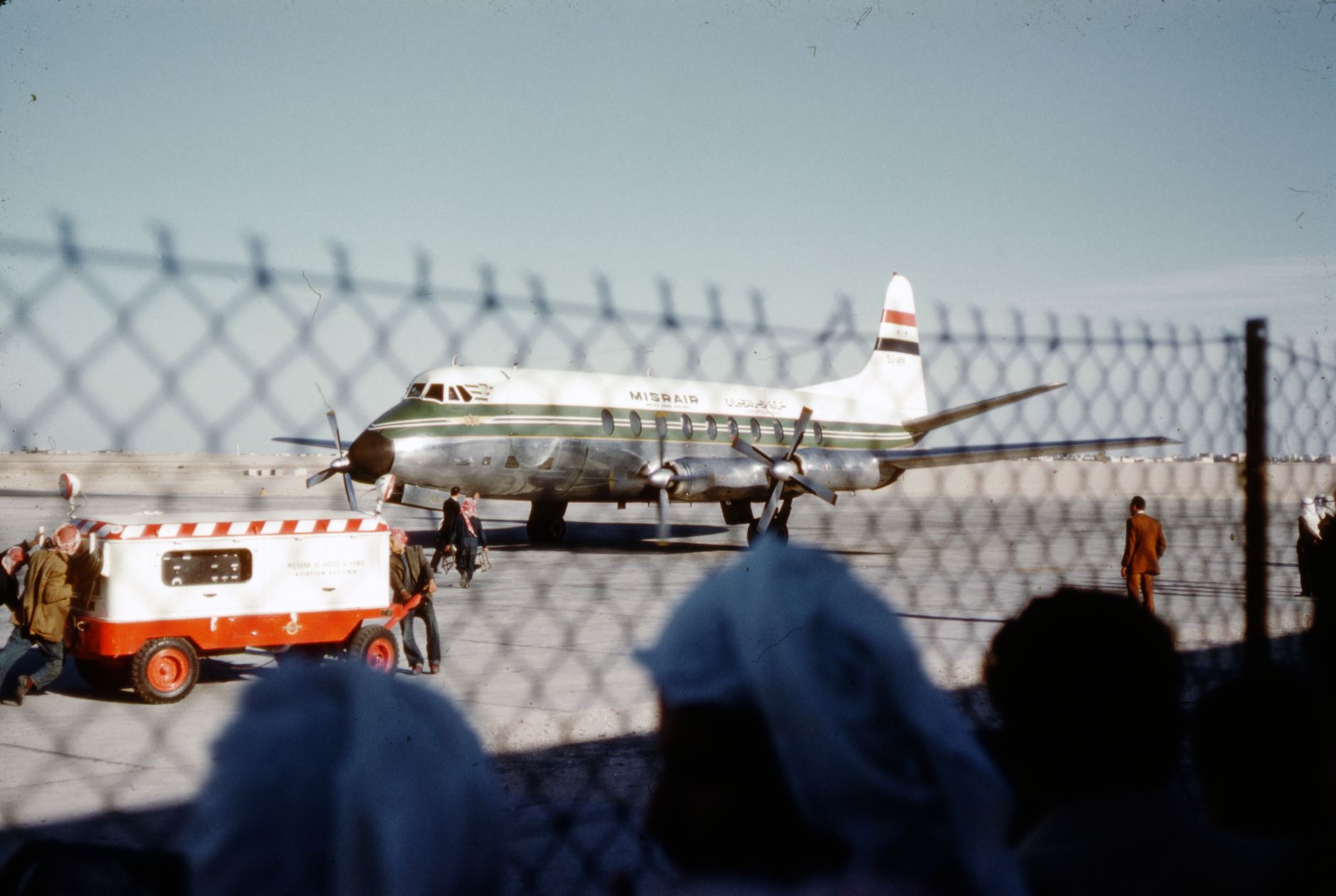 Commercial airliner on a tarmac at a Saudi Arabian airport under clear skies