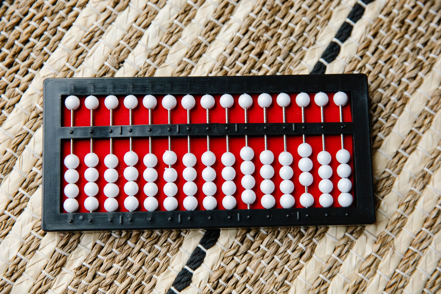 Smartphone screen showing a math puzzle game interface with colorful number tiles